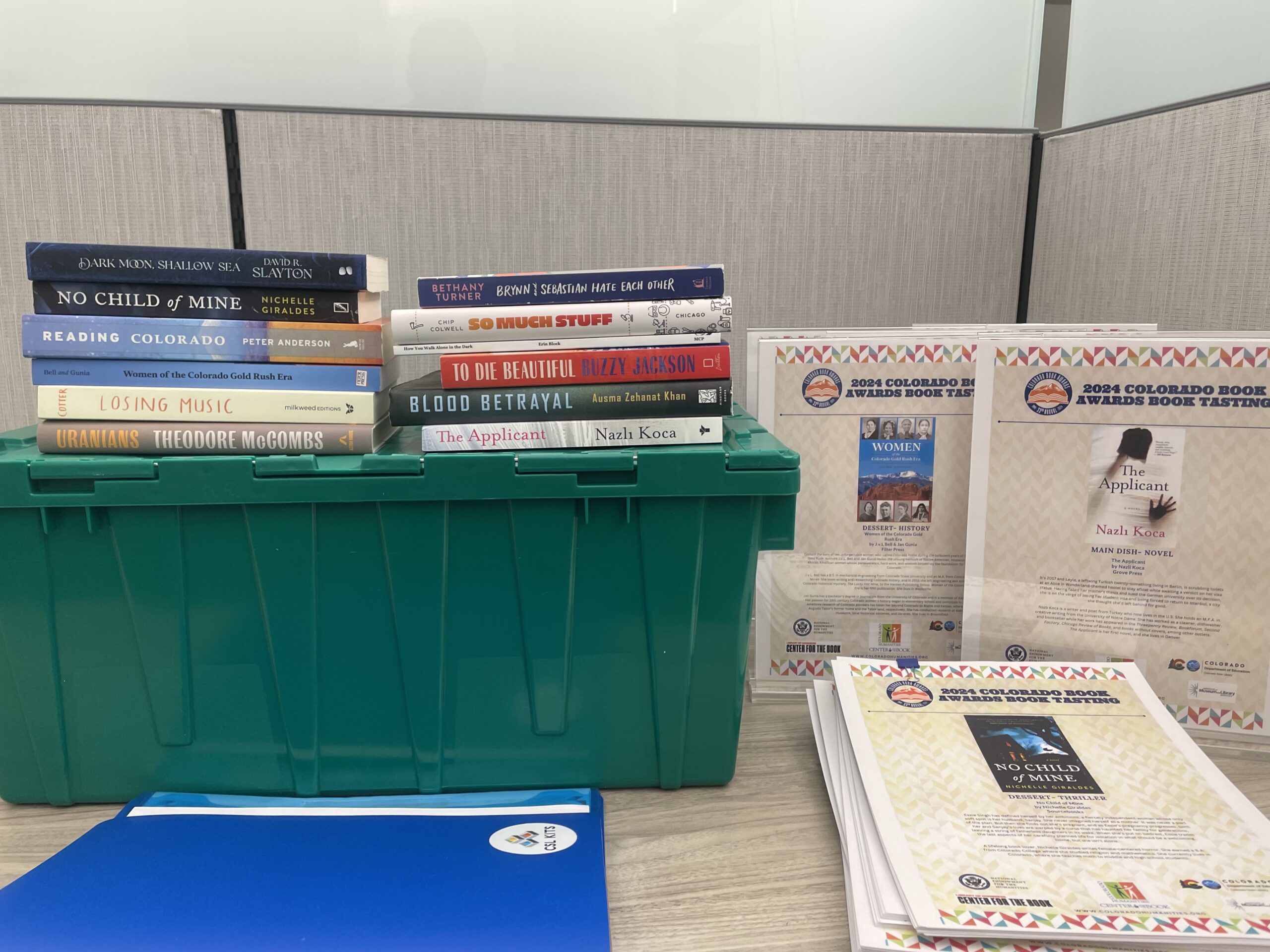 Books, a folder, a plastic tote, plastic displays and documentation